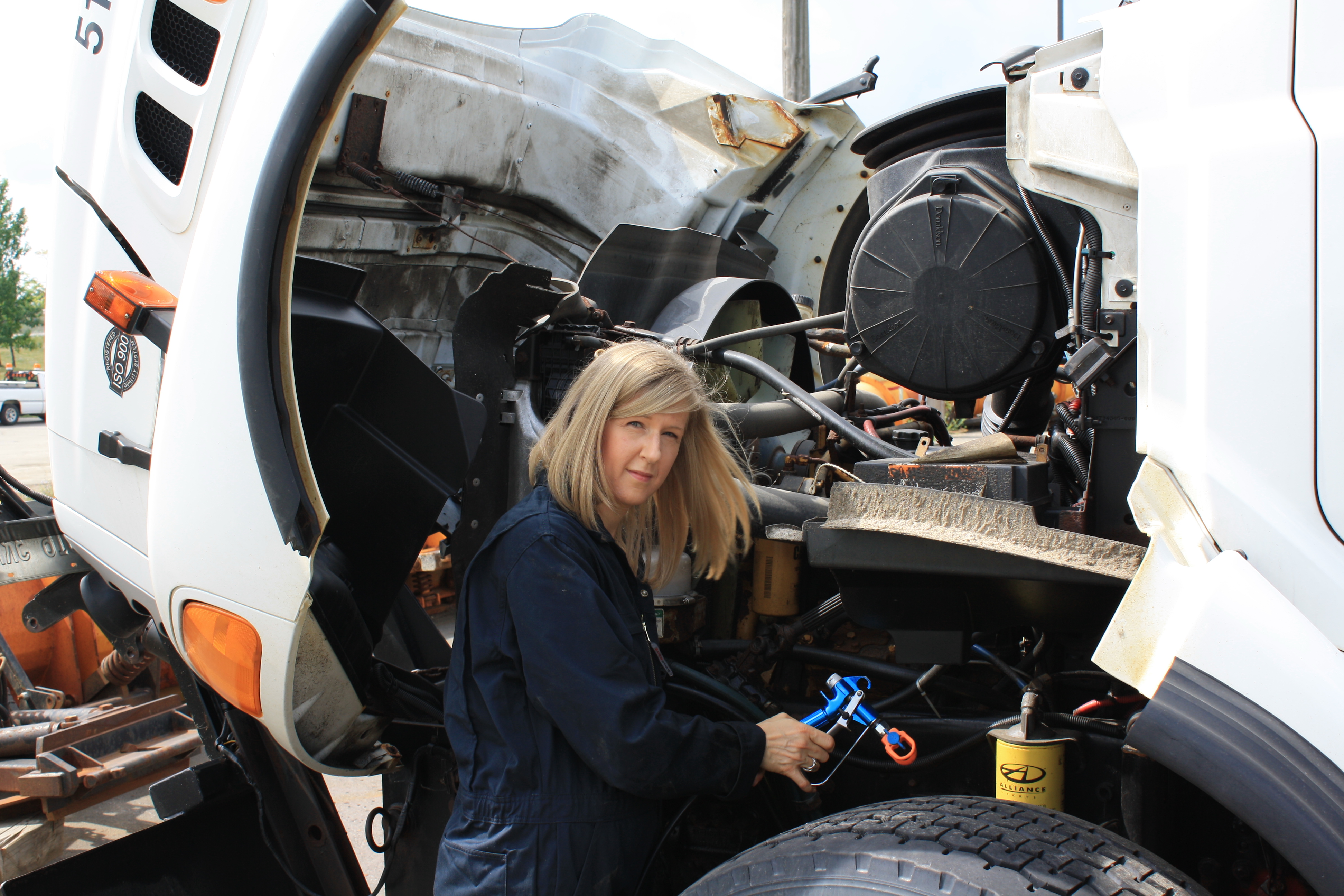 Rust-control product being applied to commercial truck components