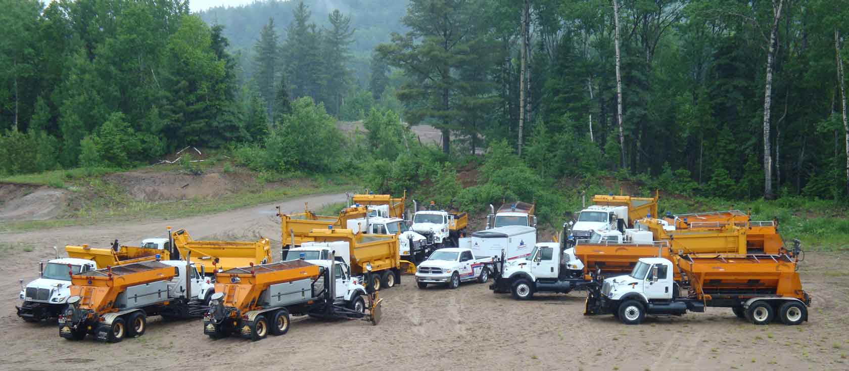 Snow-removal fleet with branded Pro Fleet Care mobile trucks and trailers